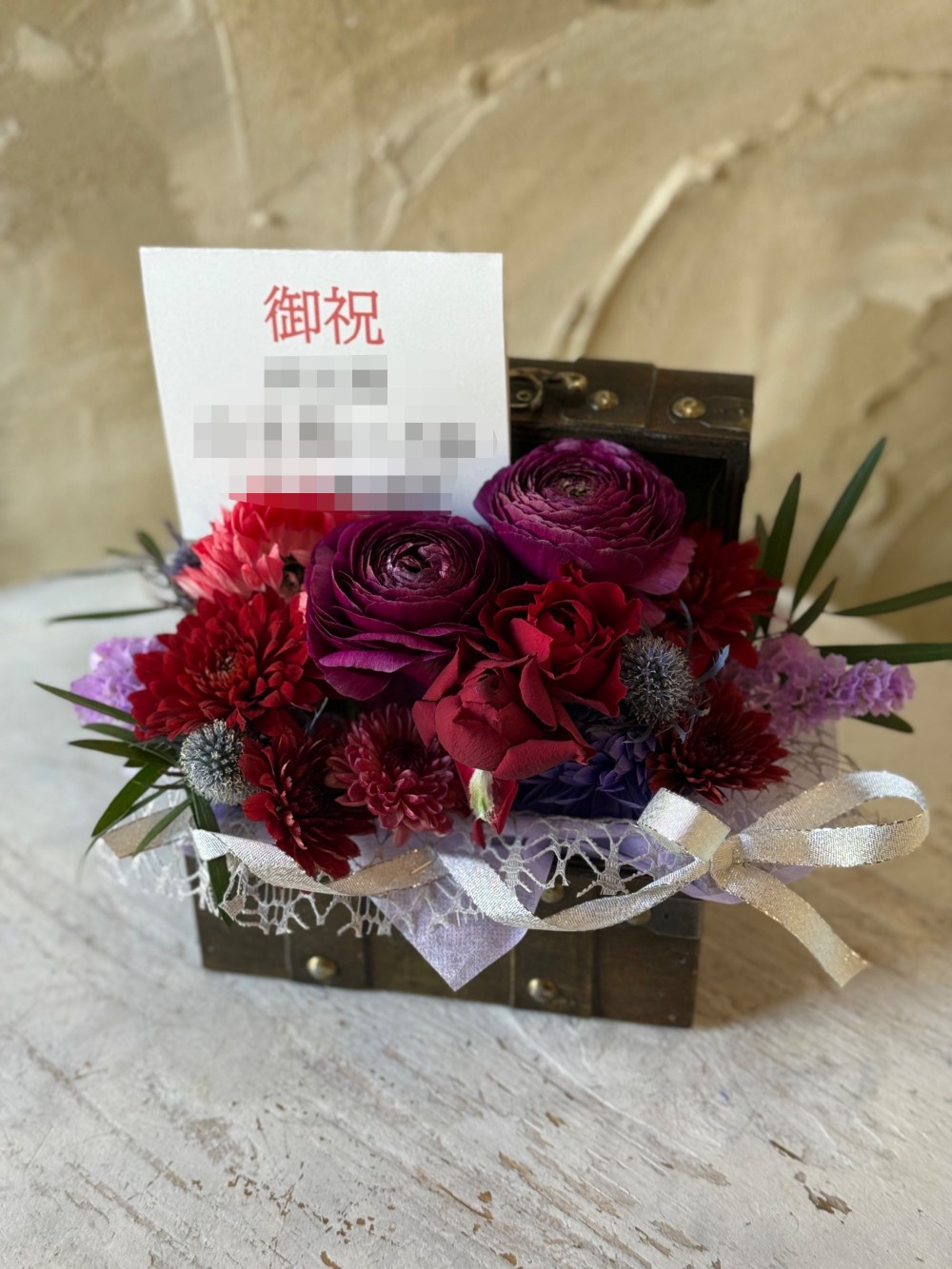 個展のお祝いにシックにおまとめしたトレジャーボックスアレンジ